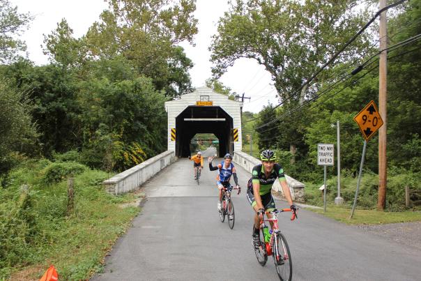 Biking over covered bridge