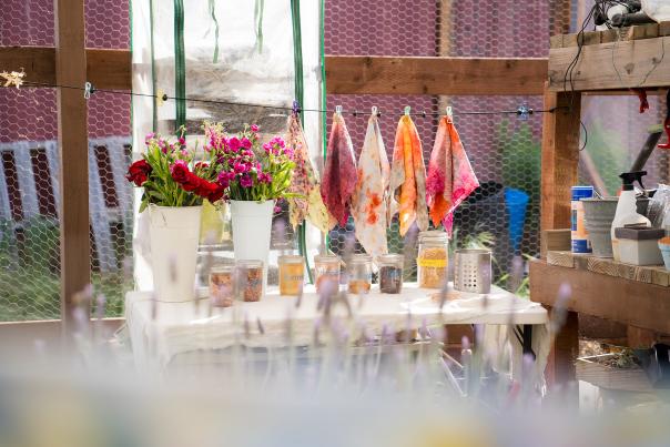 View of workbench filled with colorful flowers and jars