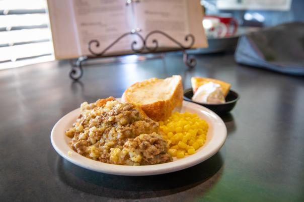 plate with tater tot hotdish corn and bread