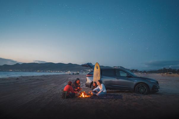 People around a bonfire on the beach