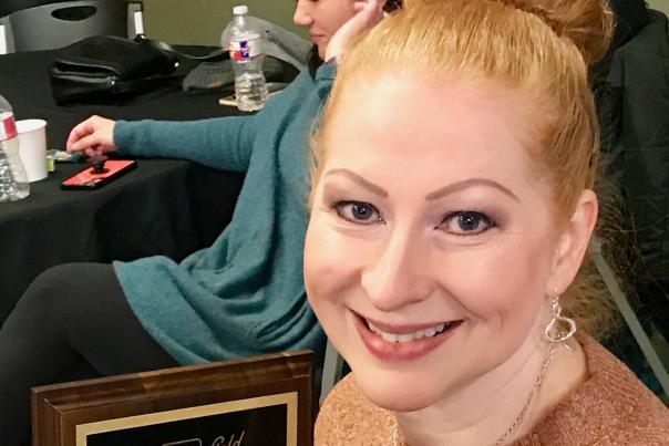 Carrie Chavez holding plaque