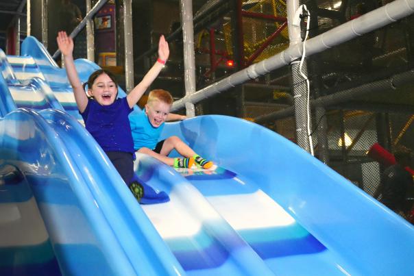 Kids On A Slide At Uptown Jungle Fun Park In Chandler, AZ