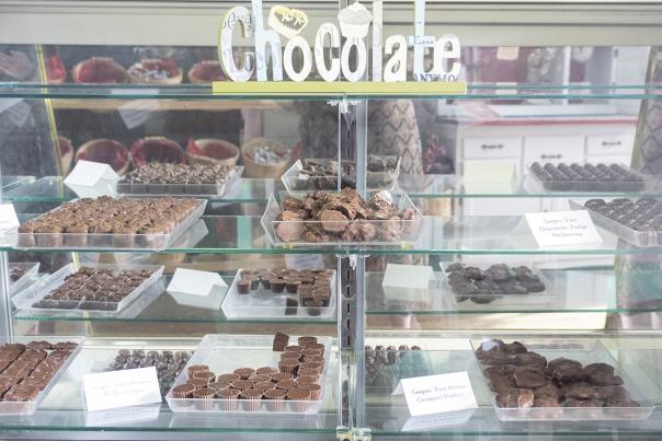 A display case filled with homemade chocolates is located at Jenny's Sweet Creations.