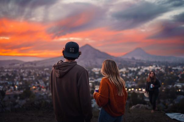 friends watching a sunset on top of Terrace Hill in SLO