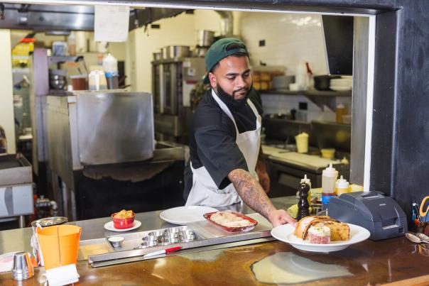 Chef serving up dishes at the window