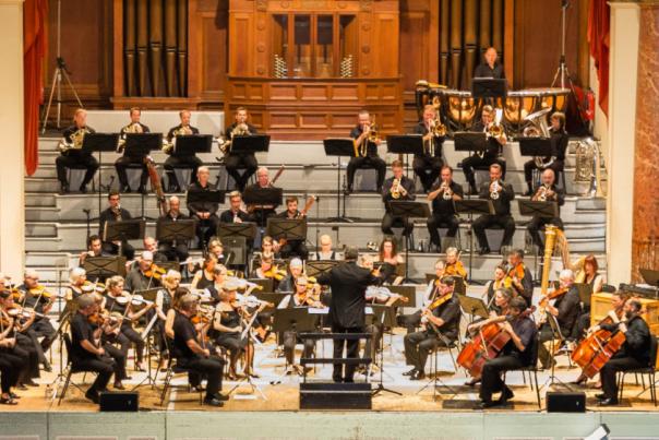 An orchestra playing classical music on a stage