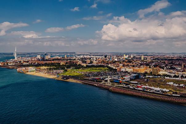 Daytime drone shot of the Victorious Festival with the Portsmouth skyline in the background