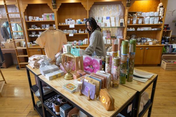 Shopper browsing the selection of products on a table inside Pure Fox in downtown rapid city,sd