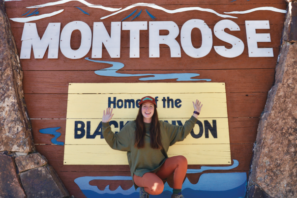 Female hiker in front of Montrose Sign