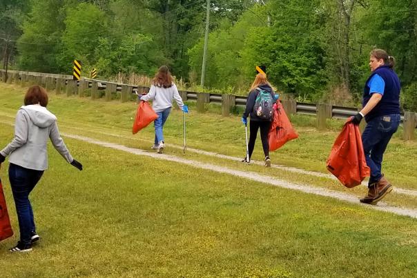 Friends Clean Up header photo depicting various volunteers cleaning up trash