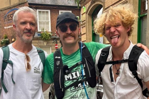 Will Dooley stands in Hull City Centre with team at the end of his Miles2Mic tour