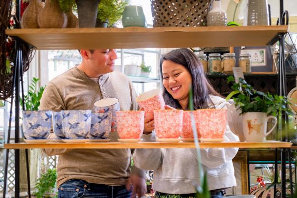 couple looking at colorful plant pots