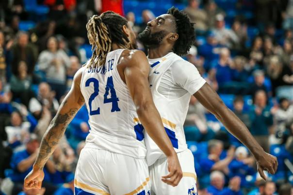 shumate and garcia chest bump to celebrate at mcneese basketball