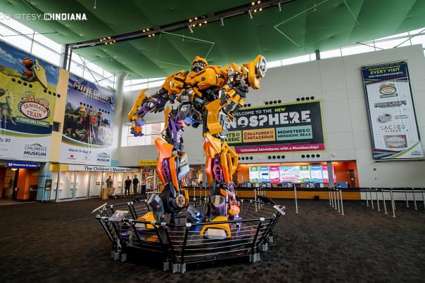 People outside the Children's Museum of Indianapolis with dinosaurs