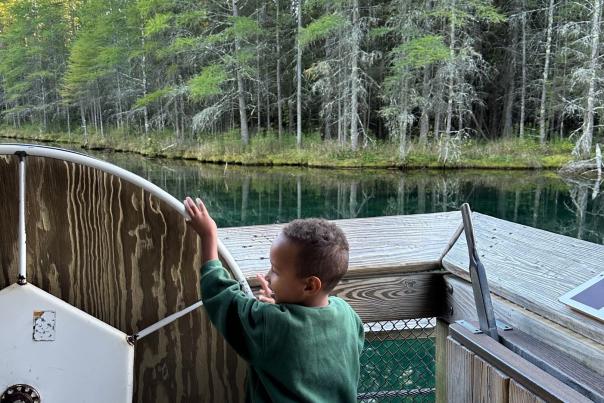 A boy exploring at Kitch-iti-kipi in the Upper Peninsula of Michigan