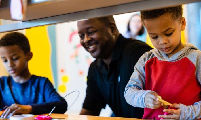 Father and two sons playing at Adventure