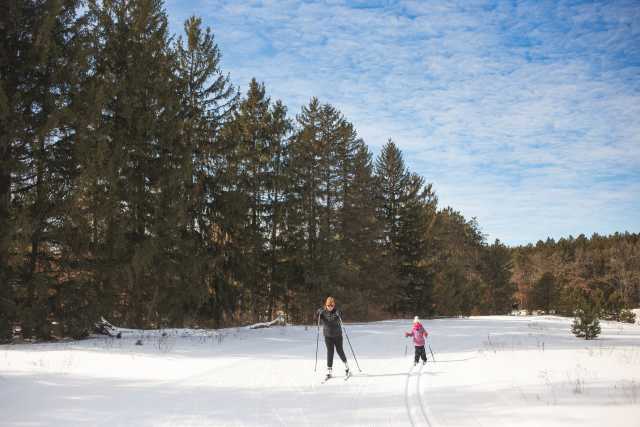 Female and young girl cross country skiing at Lowes Creek County Park