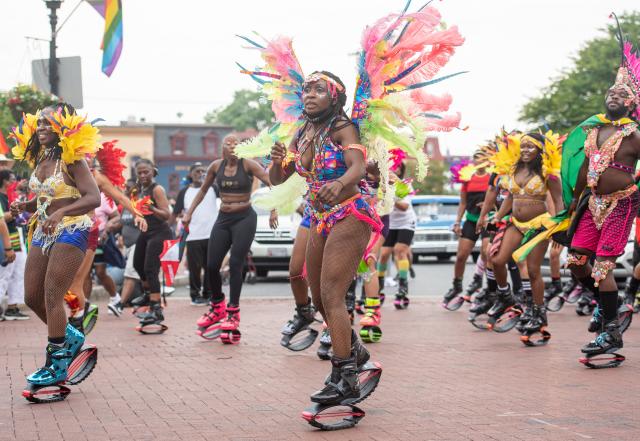 A group of black people in costumes march in the Juneteenth parade in Annapolis, MD.