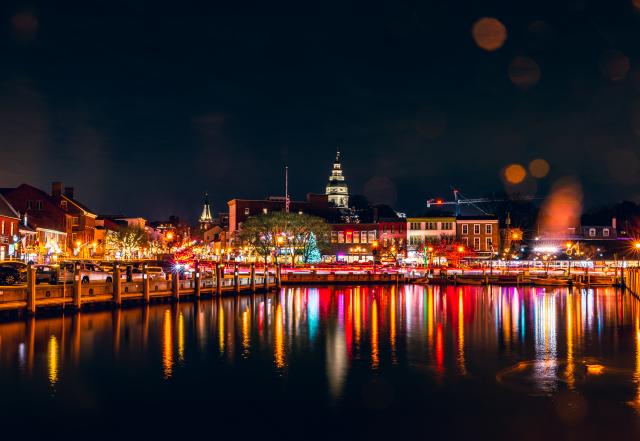 Ambient lights of red, yellow, orange, green reflecting off of City dock waters