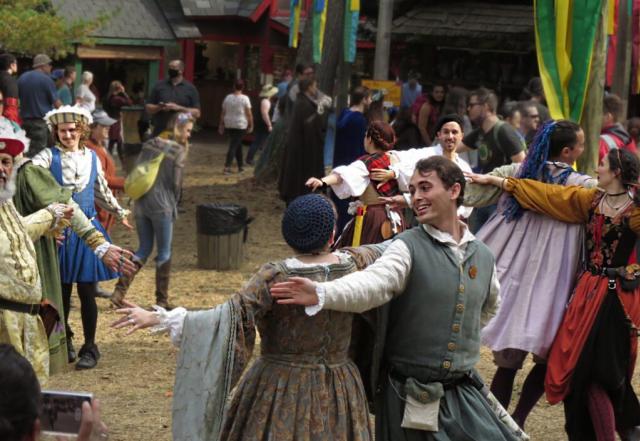 Image of people in Renaissance era clothing dancing at the Maryland Renaissance Festival