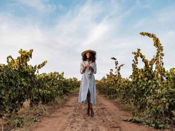 Woman Walking in Fall Vineyard