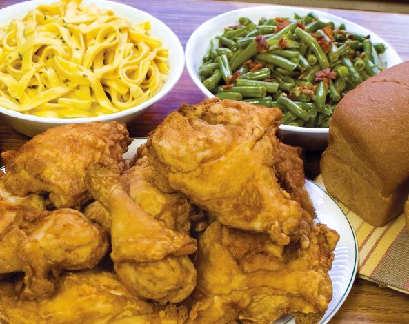 Amish style dinner of fried chicken, noodles, green beans, and bread