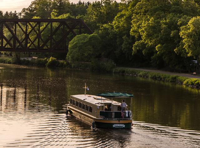 A boat sailing along the Erie Canal in Pittsford, NY