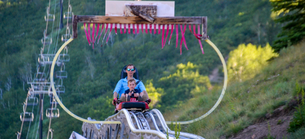 Father and Son ride down the alpine coaster at Park City Mountain