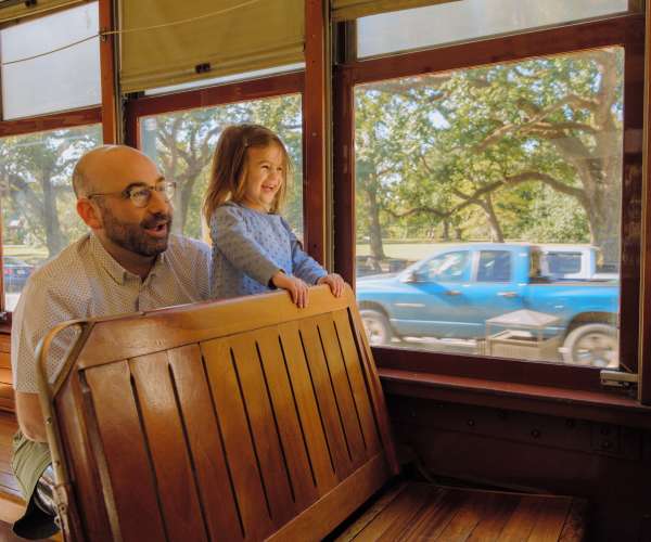 A father and daughter enjoying the St. Charles Avenue Streetcar together