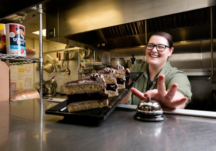 Lady handing out cake