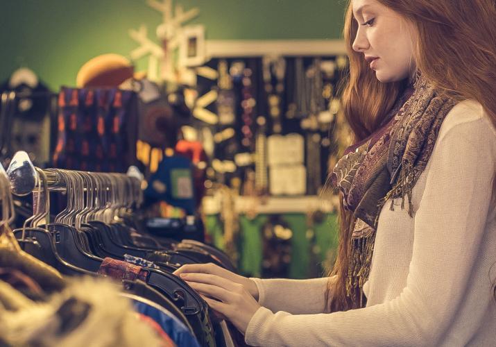 woman looking through clothes rack