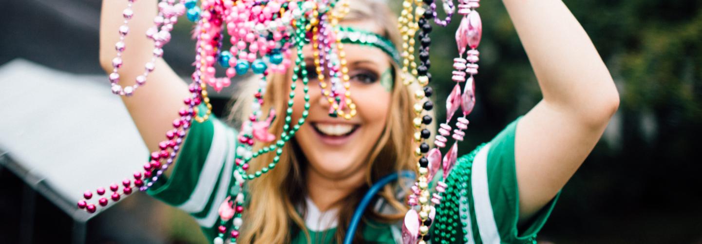 Woman holding beads during St. Patrick's day parade