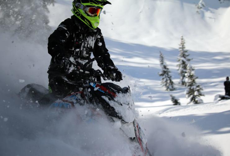 Snowmobiling in the snow at Beaver Creek Lodge