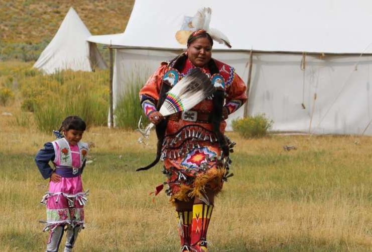 Native American woman dancing in ceremonial clothing
