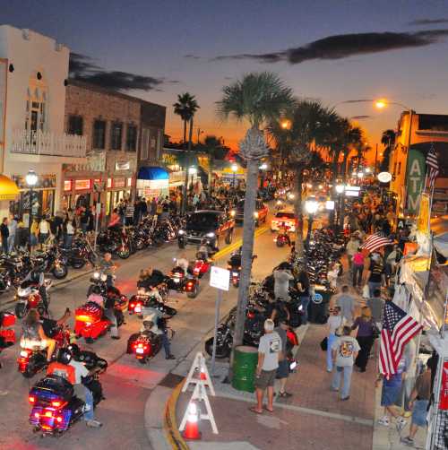 Motorcycle riders line Main Street at sunset