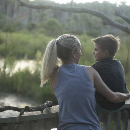 A family overlooking an inland waterway while enjoying area parks and trails.