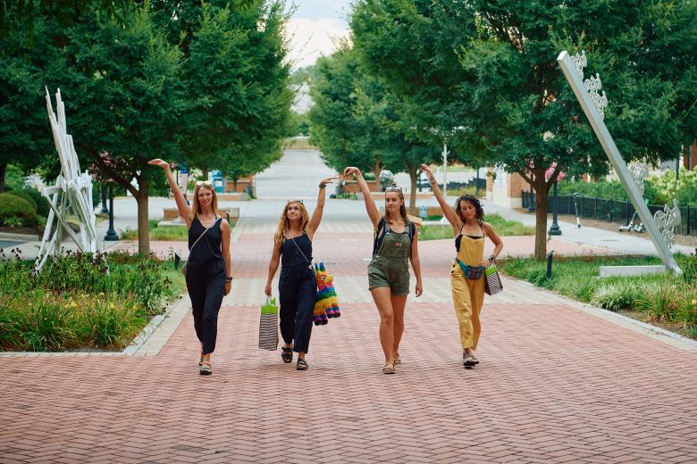 influencer summer camp women walking down the sidewalk