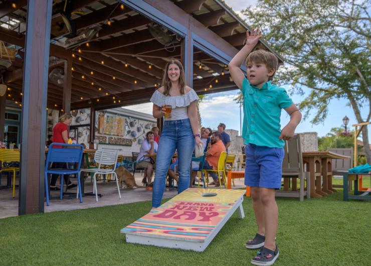 Family at Crooked Hammock playing cornhole