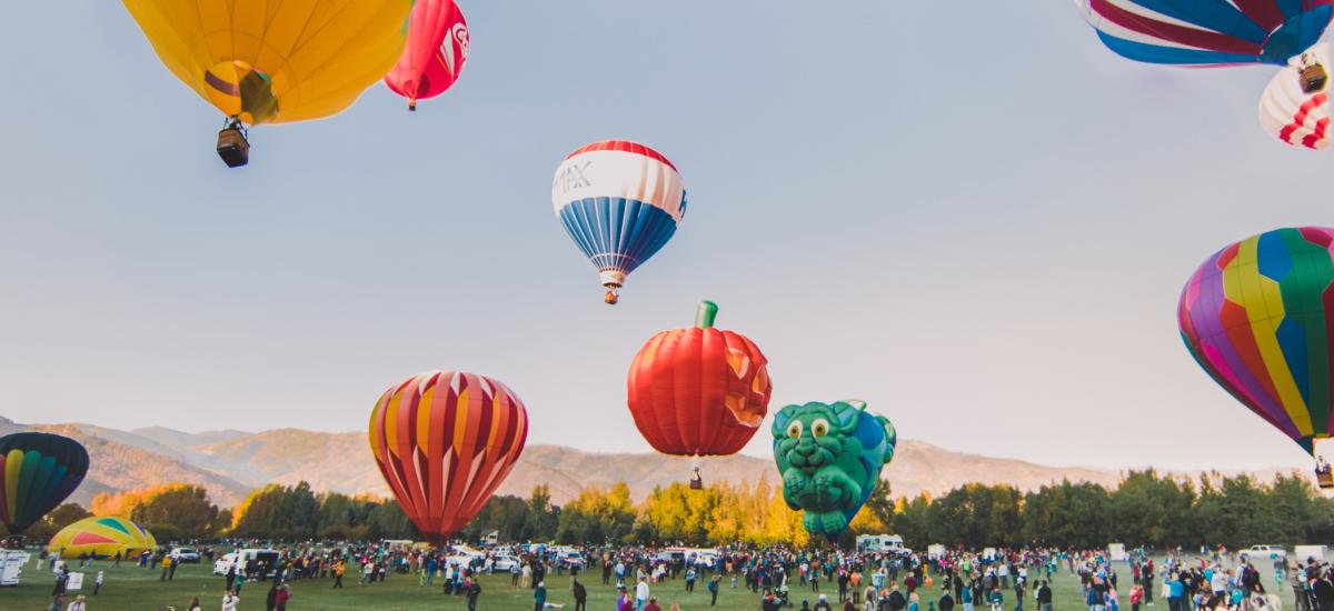a group of hot air balloons taking off into the air