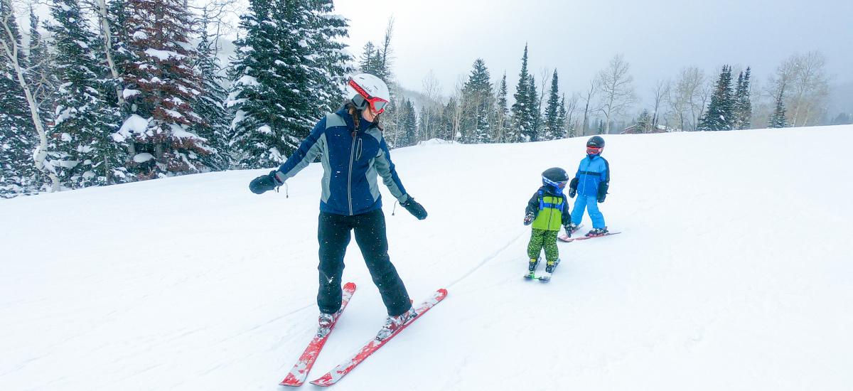 Mother Skiing with her two young kids