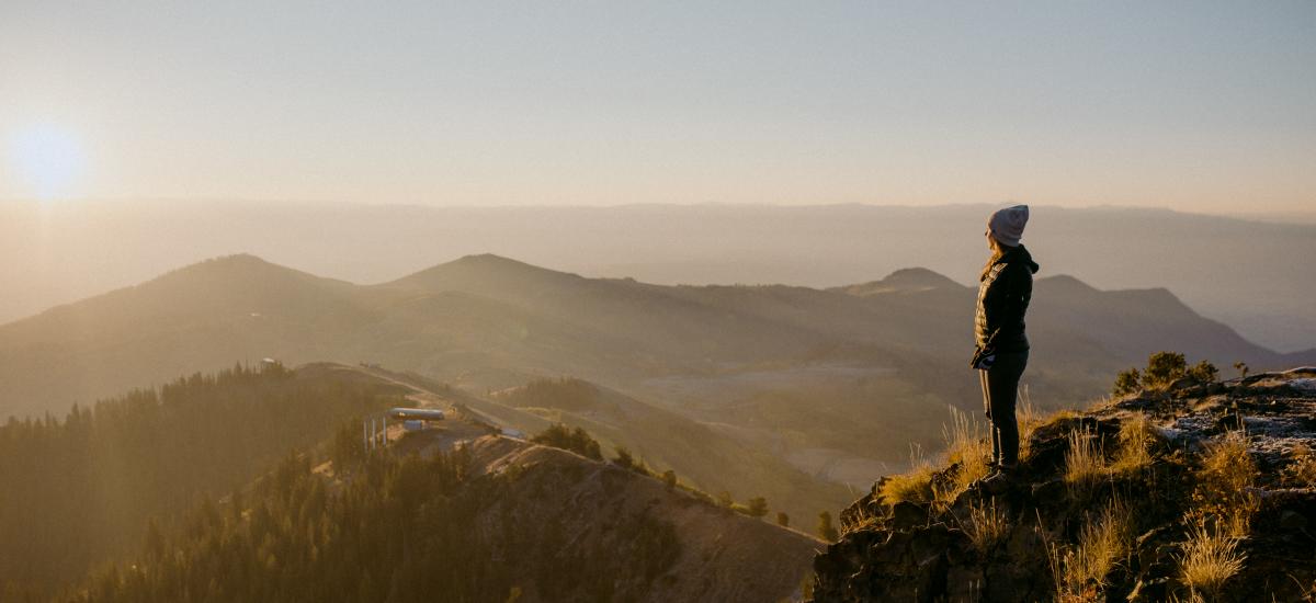 Woman on top of Mountain looking out at Park City, Utah
