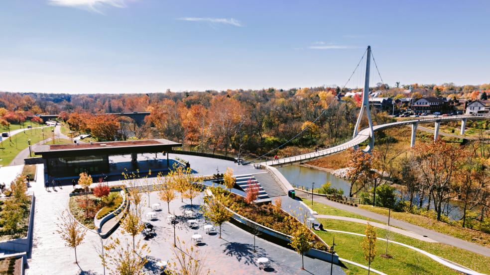 Riverside Crossing Park and the Dublin Link pedestrian bridge surrounded by fall color.