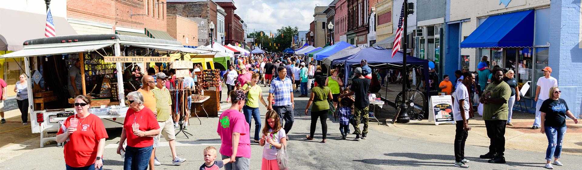 People shopping at vendors during the Selma Railroad Days Parade in Selma, NC.
