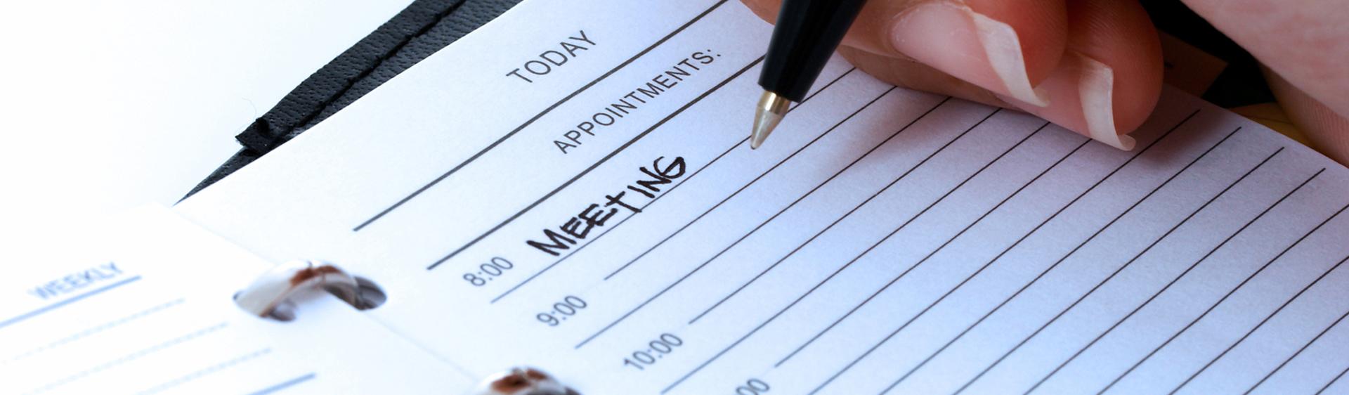 The word "Meeting" written on a schedule for posting up Johnston County Tourism Authority board meetings.