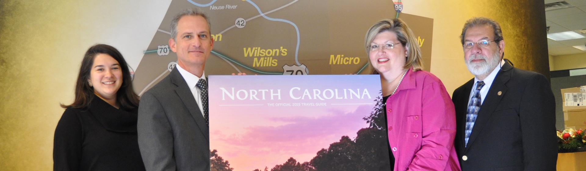 Bentonville Battlefield is featured on the cover of the 2015 NC Travel Guide, presented to Lynn Daniels, Donna Bailey-Taylor and Donny Taylor by Wit Tuttell.