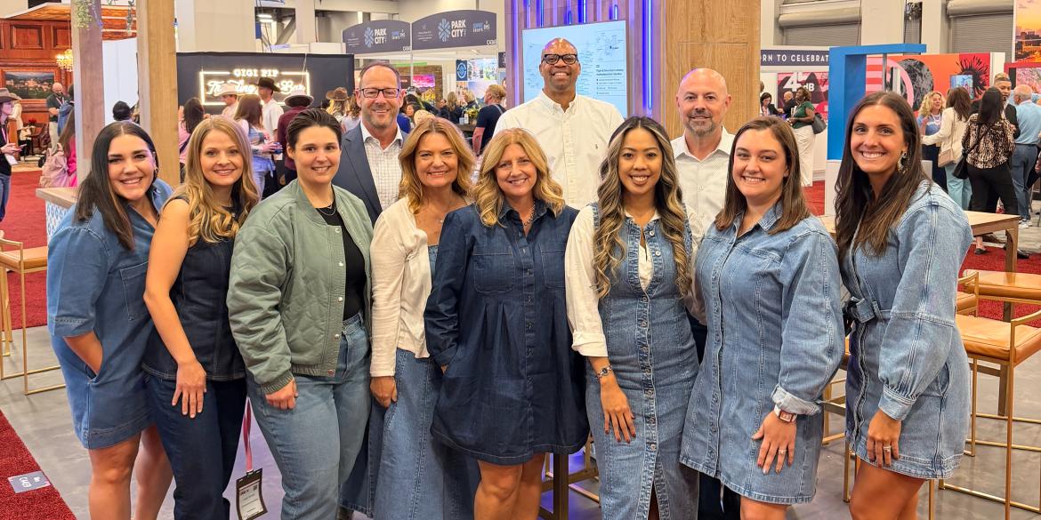 Experience Columbus team standing in front of Columbus booth at IMEX 2025 conference