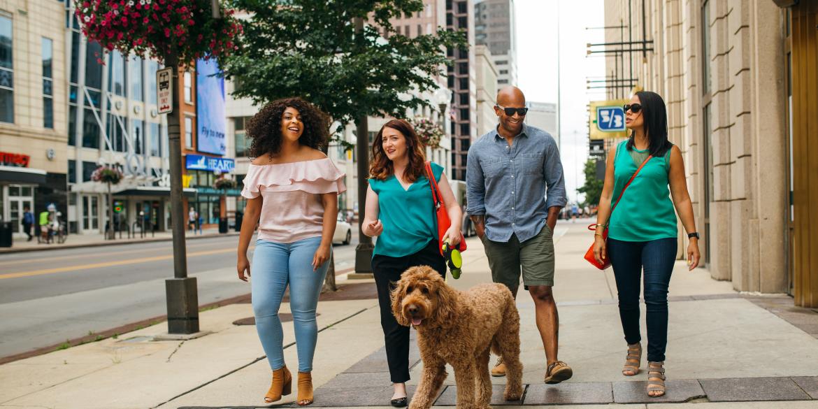 Group of friends and their dog walking around downtown Columbus
