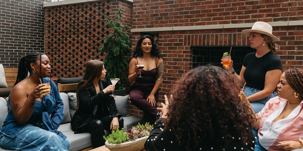 Group of women enjoying drinks at Brass Eye