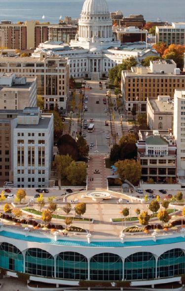 A wide view of the Madison skyline featuring Monona Terrace and the Capitol building in the background.