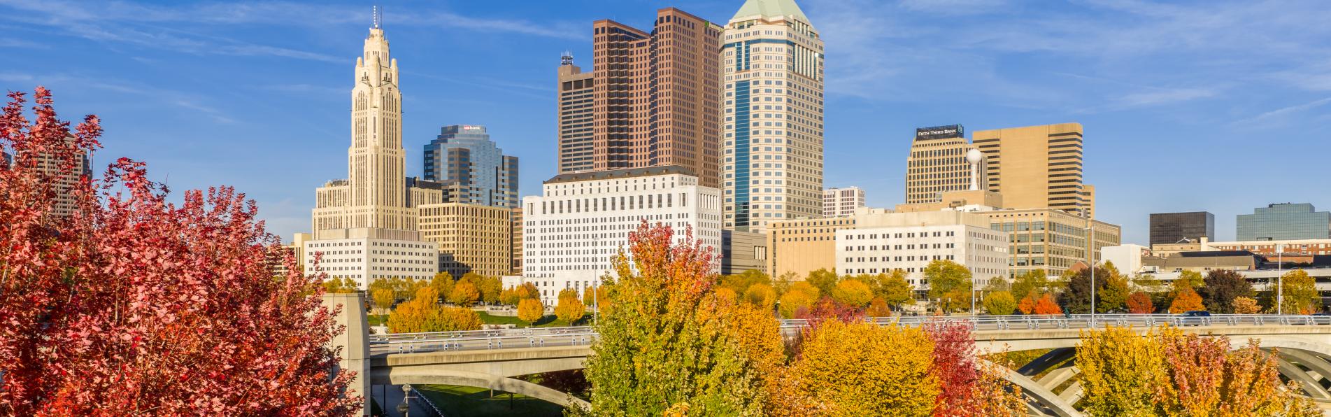 Columbus skyline in the background, fall colored trees in the foreground